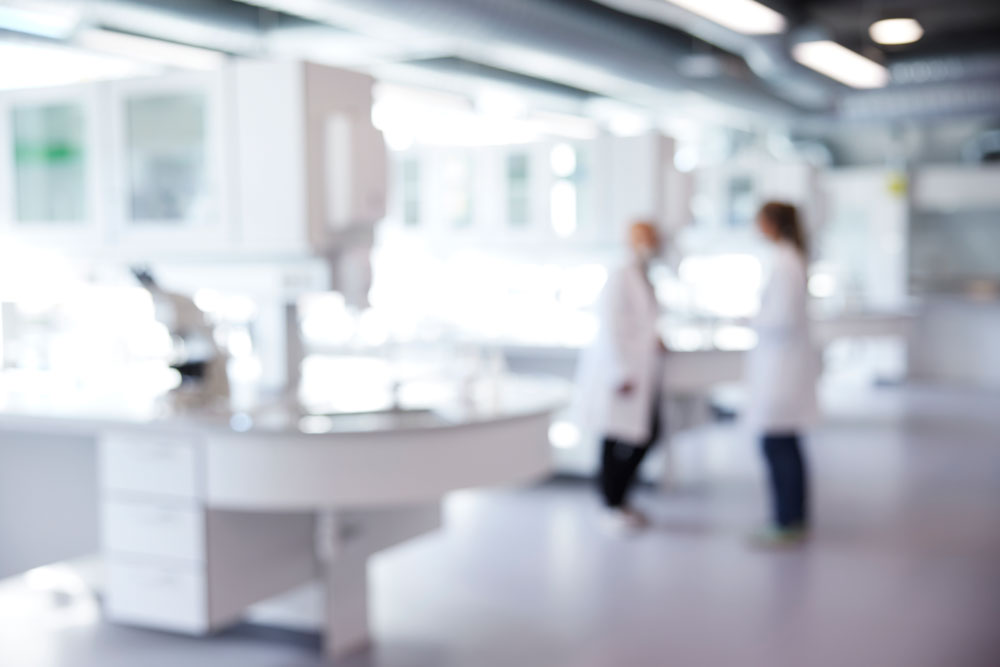 Defocused image of laboratory with two scientist